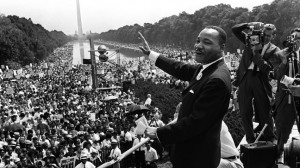 The civil rights leader Martin Luther KIng (C) waves to supporters 28 August 1963 on the Mall in Washington DC (Washington Monument in background) during the "March on Washington"