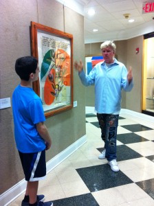Artist Peter Tunney introducing pictures to Pine Crest student