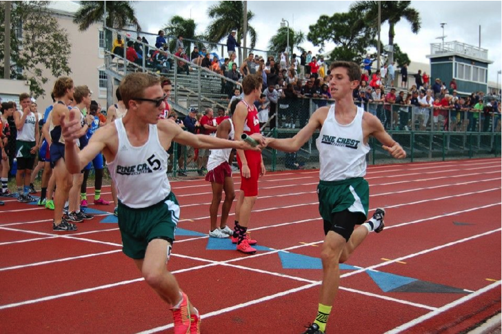 Ryan Welch (right) is 
handing the baton to Michael Kennedy (left) during a recent home meet. (Via Michael Kennedy, sophomore) 

