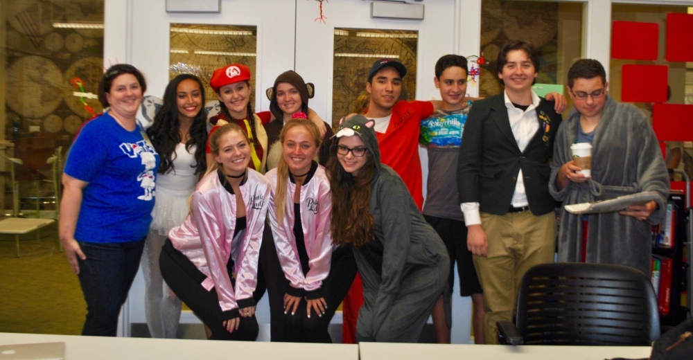 Ms. Everett shares a photo with some dressed up seniors.  (via Sydney Aronberg, junior)