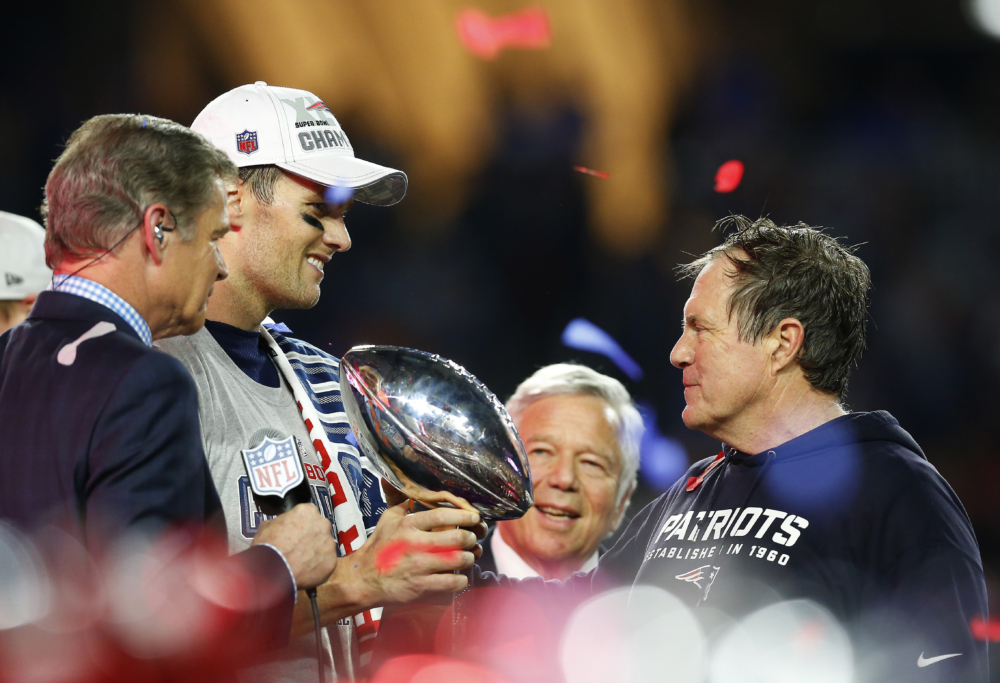 GLENDALE, AZ - FEBRUARY 01:   Tom Brady #12, team owner Robert Kraft, and head coach Bill Belichick of the New England Patriots celebrate with the Vince Lombardi Trophy after defeating the Seattle Seahawks 28-24 to win Super Bowl XLIX at University of Phoenix Stadium on February 1, 2015 in Glendale, Arizona.  (Photo by Tom Pennington/Getty Images)