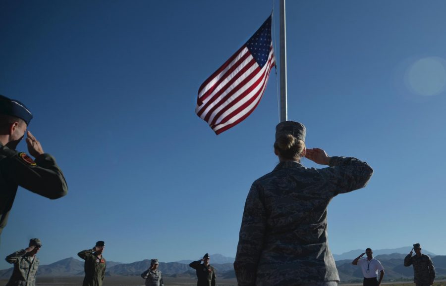 Creech Air Force Base members salute the flag in honor of the Las Vegas shooting victims (via Photo by Airman 1st Class Haley Stevens)