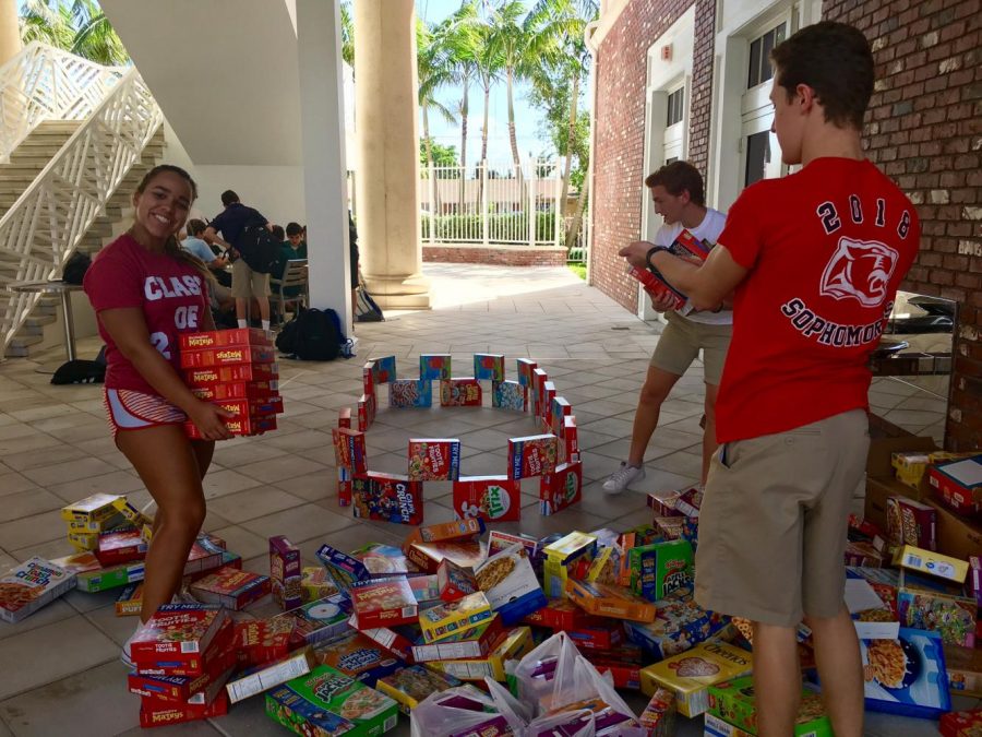 Seniors work on building their throne with cereal boxes in the atrium. 