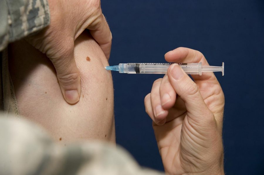 A flu vaccine is administered to an airman at Transit Center at Manas, Kyrgyzstan.