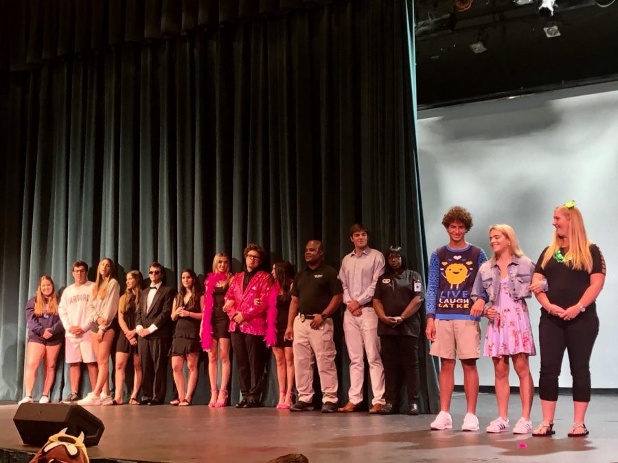 Homecoming Court nominees stood onstage as Mr. Curran read humorous speeches about them.
