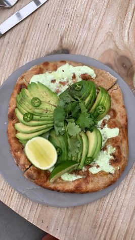 Avocado pizza is one of the most popular dishes served at Malibu Farm (via Olivia Winnick)