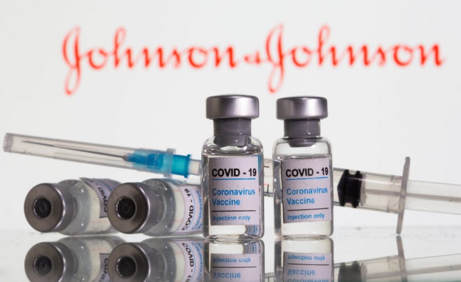 Vials labelled "COVID-19 Coronavirus Vaccine" and sryinge are seen in front of displayed Johnson&amp;Johnson logo in this illustration taken, February 9, 2021. REUTERS/Dado Ruvic/Illustration