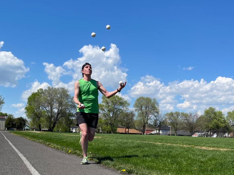 Michal Kapral, the Canadian Guinness World Record-holder, is practicing before an upcoming race. Typically, jogglers use three balls during their runs, but sometimes they use five like in this photo. The saying "don't drop the ball" has taken on an entirely new meaning for those who practice joggling. 