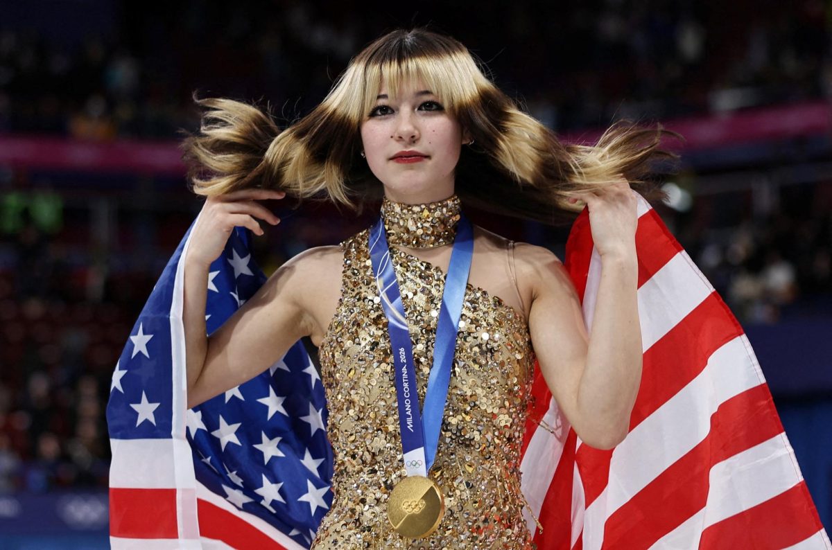 Milano Cortina 2026 Olympics - Figure Skating - Women Single Skating - Victory Ceremony - Milano Ice Skating Arena, Milan, Italy - February 19, 2026. Gold medallist Alysa Liu of United States celebrates with her national flag after winning the Women Single Skating REUTERS/Amanda Perobelli     TPX IMAGES OF THE DAY